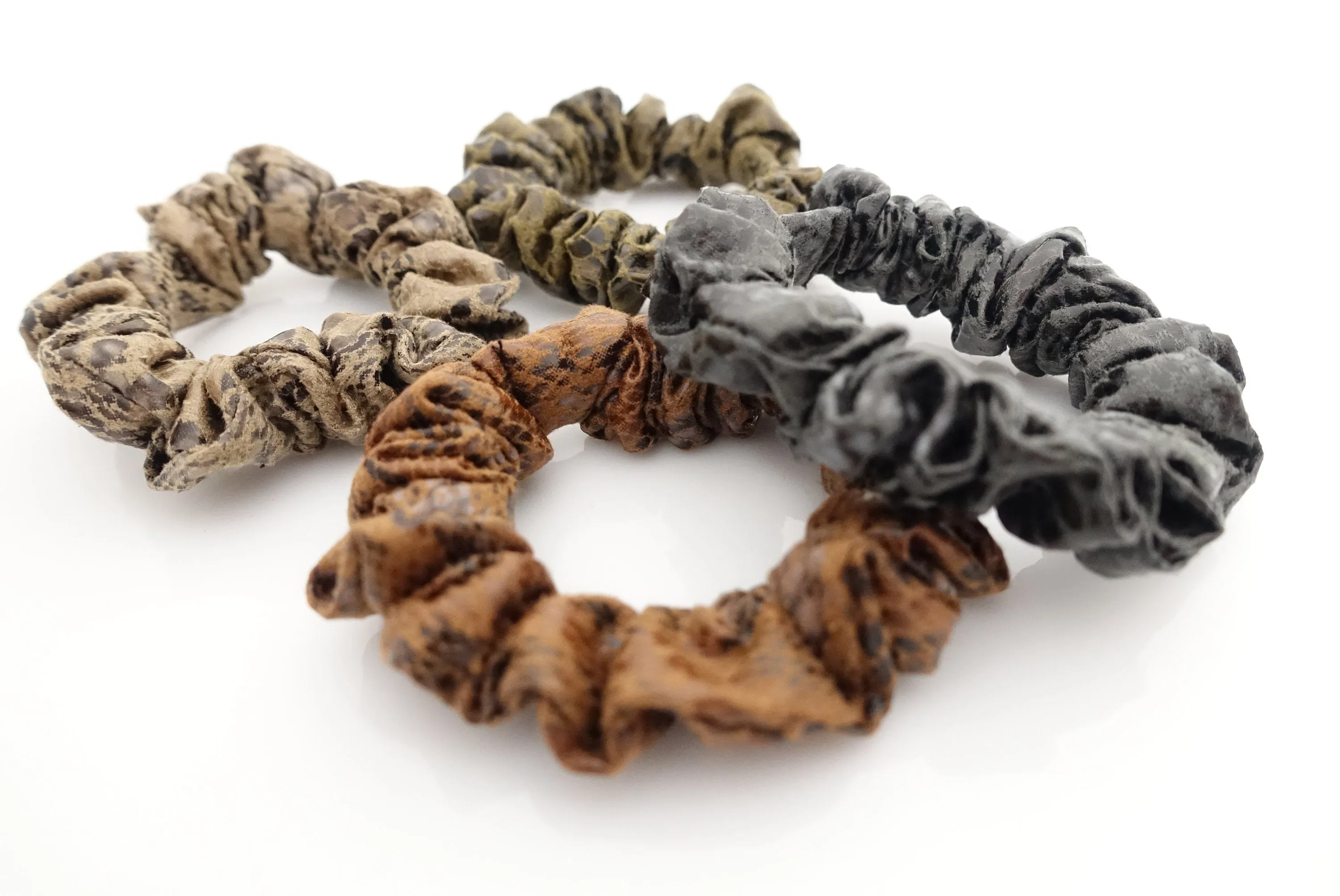 a set of 4 thin faux leather scrunchies stylish hair tie ponytail holder pack for women