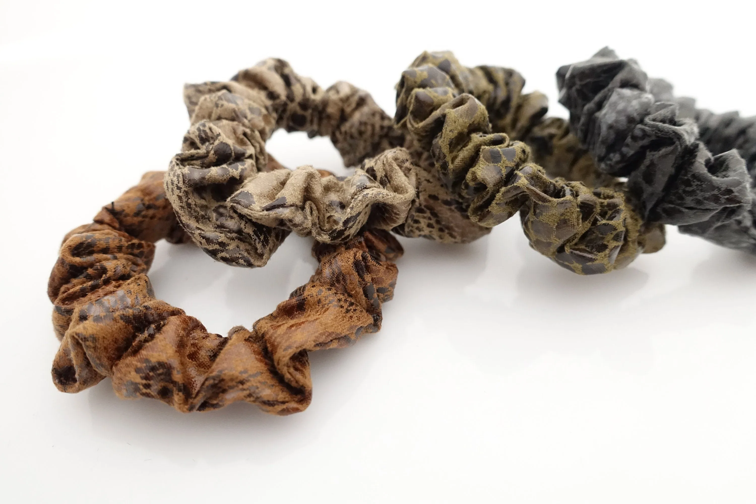 a set of 4 thin faux leather scrunchies stylish hair tie ponytail holder pack for women